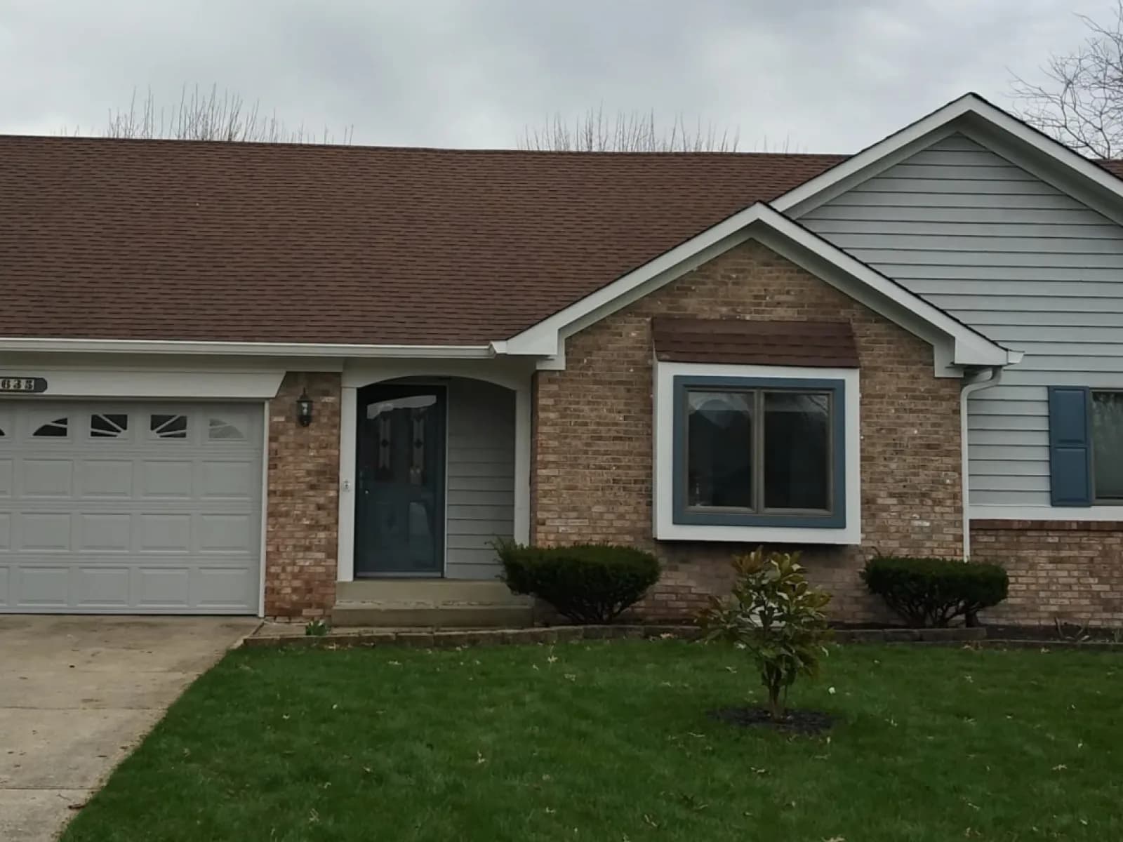 Ranch siding and shutters repainted, brick left alone